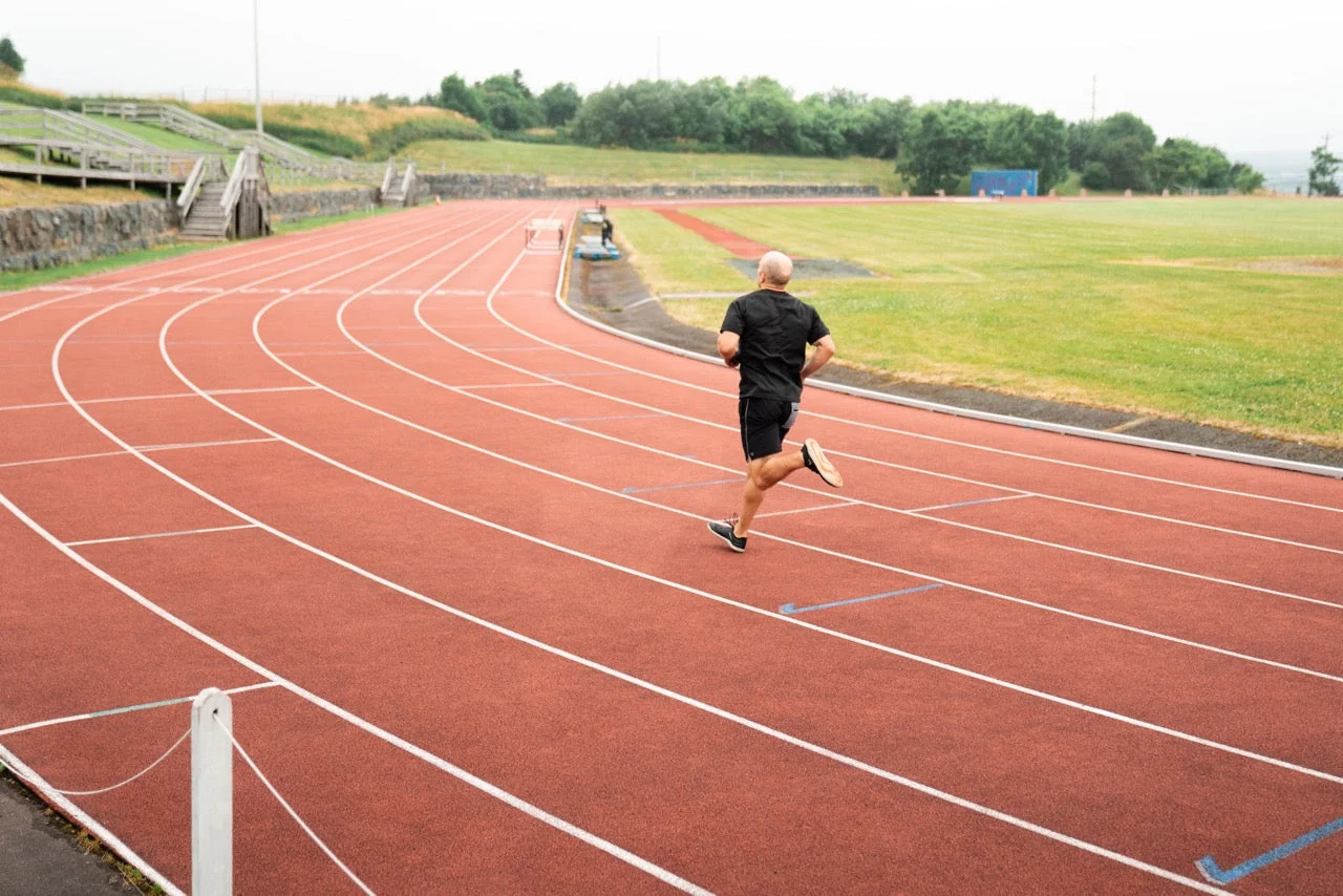A runner on a red running track